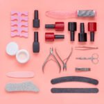 nail tools nail polish, files, scissors, clippers, set of fingernails polish. manicure and pedicure accessory on pink background.